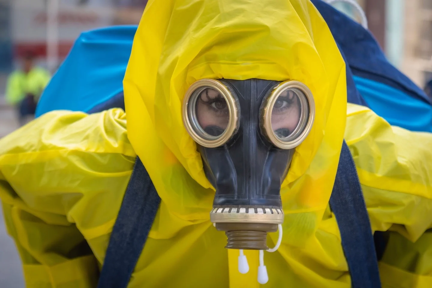 Person in a yellow hazmat suit looking up at the camera.